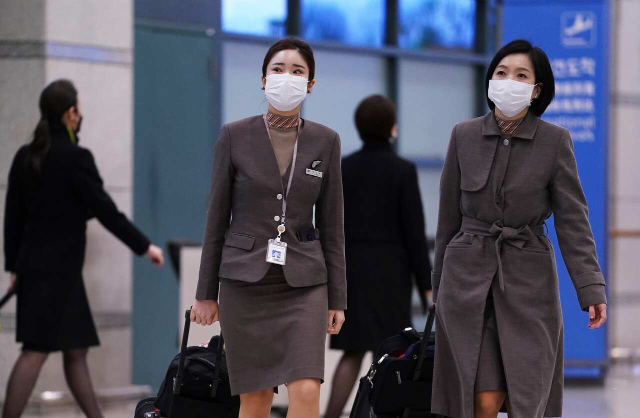 Airline staff wear masks at a South Korea airport.