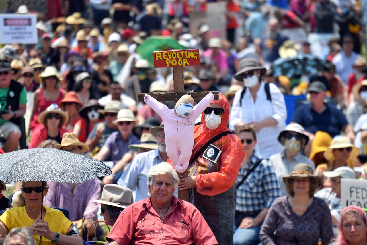 Climate change activists protest outside Parliament House in Canberra.