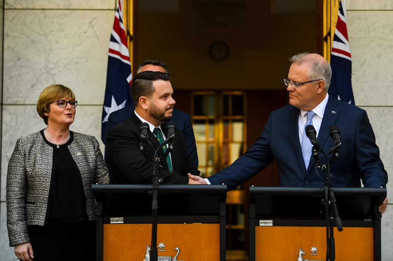 Prime Minister Scott Morrison and Liberal MP Phillip Thompson shake hands at Parliament House.