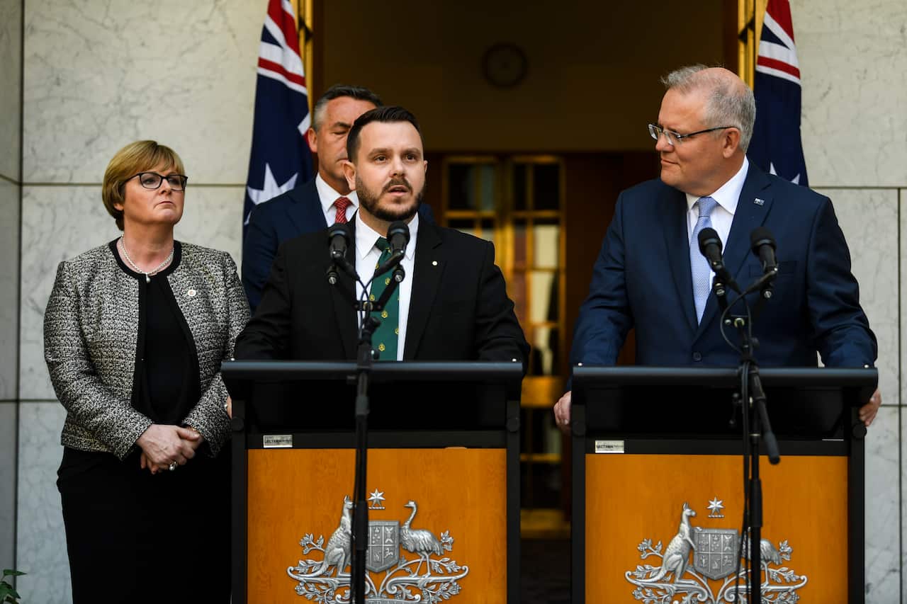 Prime Minister Scott Morrison listens to Liberal MP and veteran Phillip Thompson as he speaks at Parliament House in Canberra. 