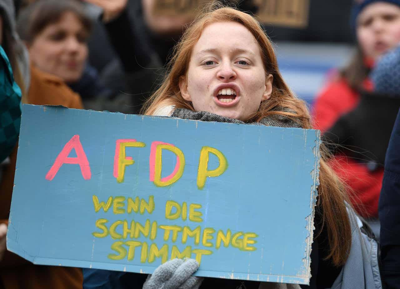 A demonstrator holds a placard during a protest against the Free Liberal Democrats party (FDP) in front of the State Chancellery in Erfurt, Germany.