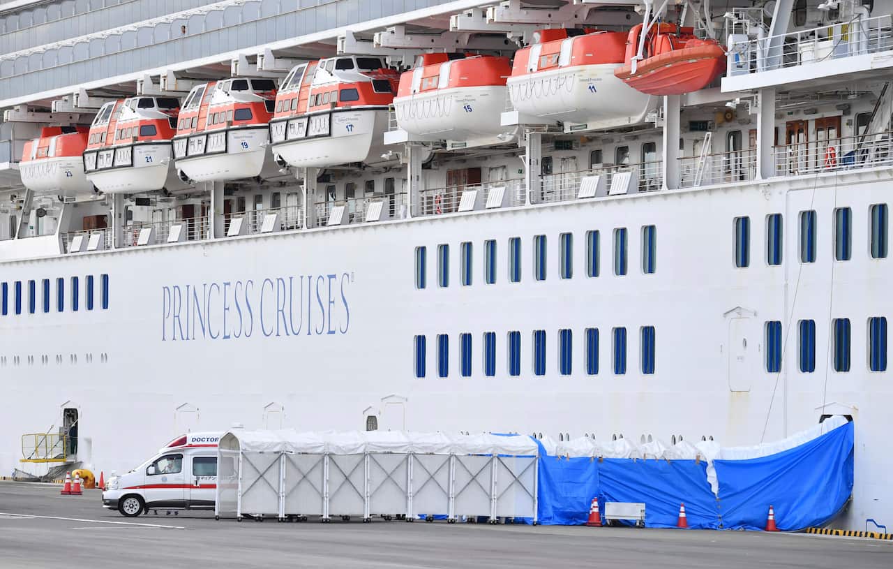 Princess Diamond passengers who tested positive in a new coronavirus test are carried to an ambulance at the Yokohama port in Kanagawa Prefecture.