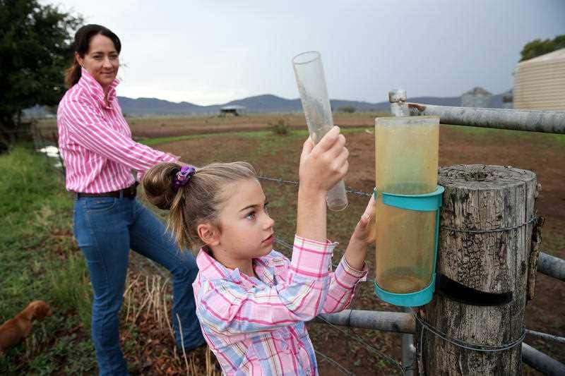 Felicity Mammen, 7, checks the rain gauge with mum Janice Mammen on the family's farm in north west NSW in February.