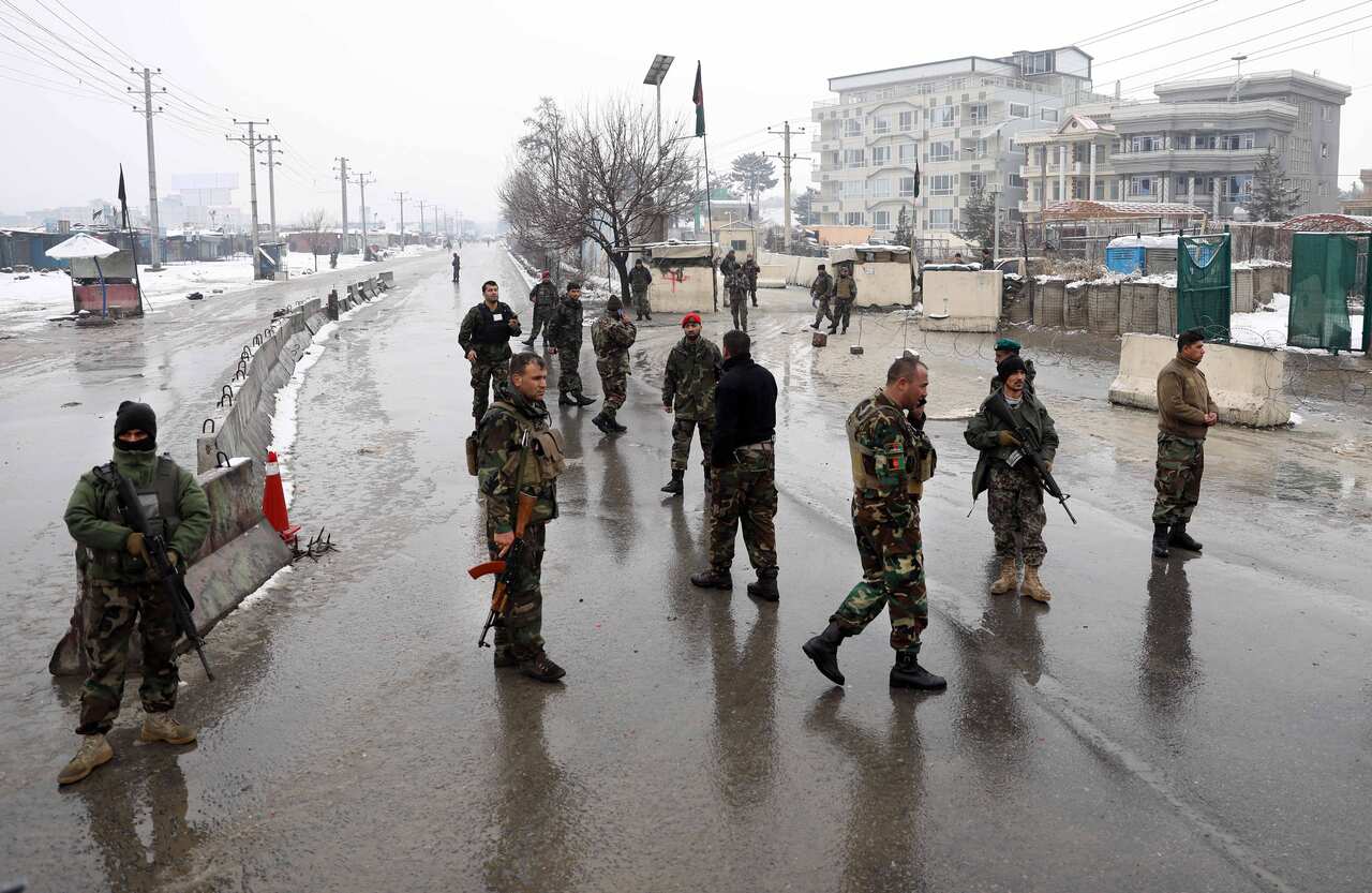 Afghan security officer stands guard.