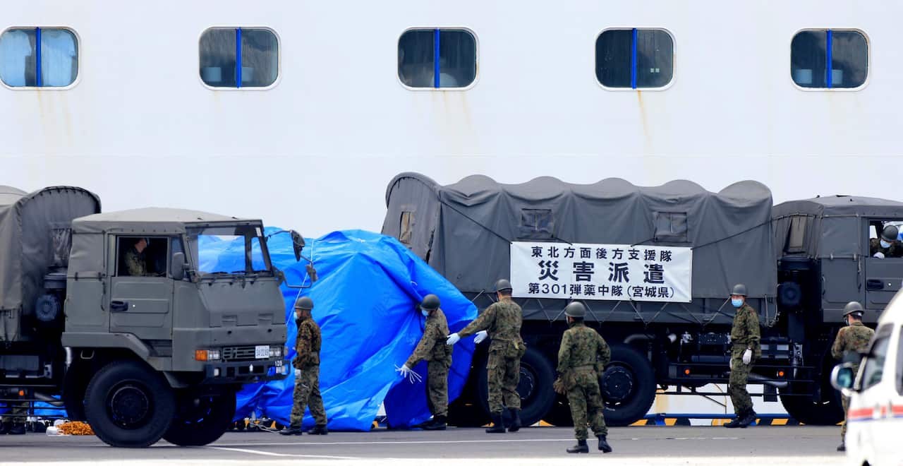 Members of the Self-Defense Forces help upload food and medical supplies at the Diamond Princess.