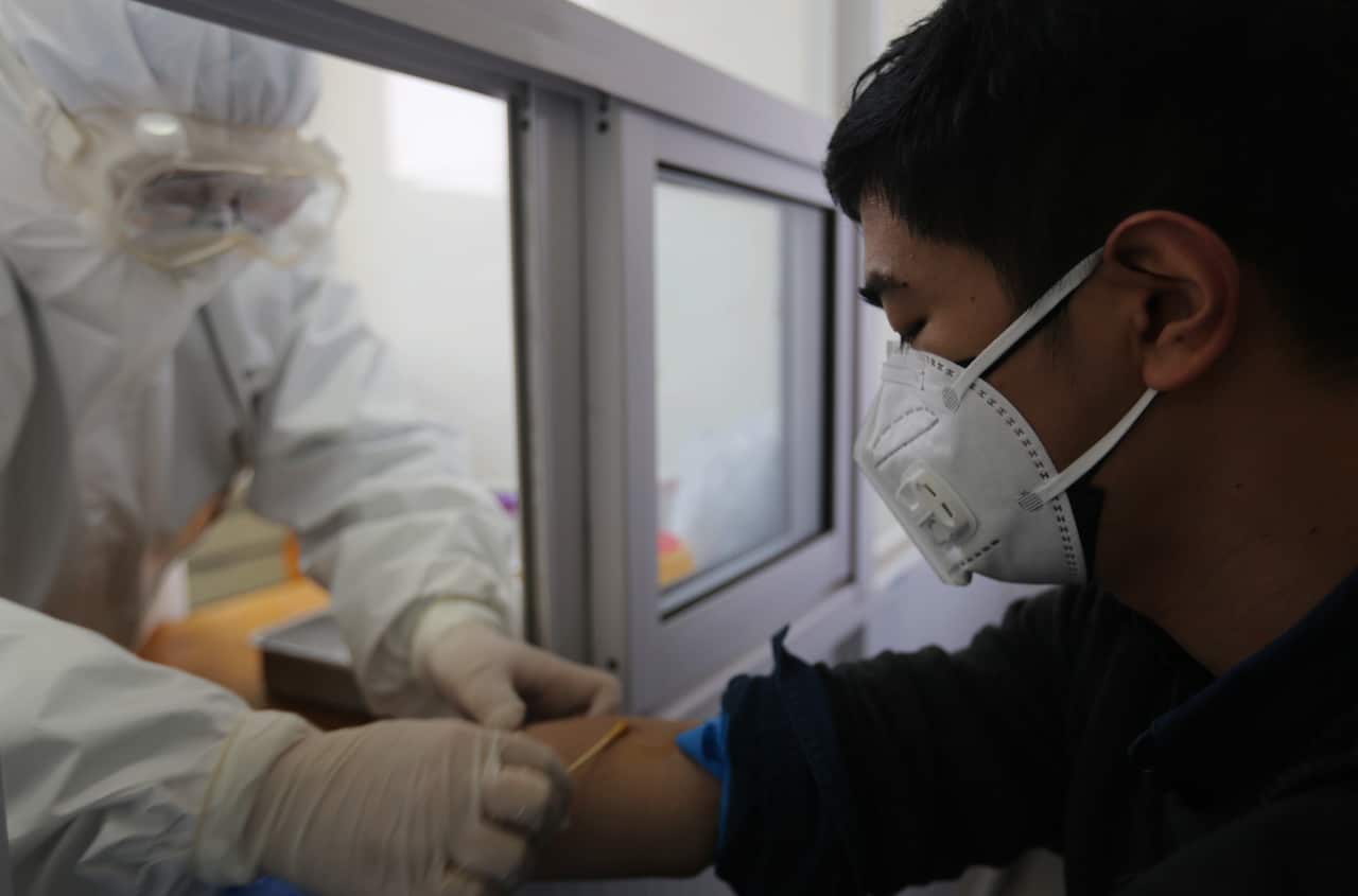 A nurse treats a patient in a fever clinic in Yinan County, in east China's Shandong province.