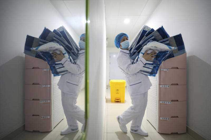 A worker prepares medical supplies at the Jinyintan Hospital
