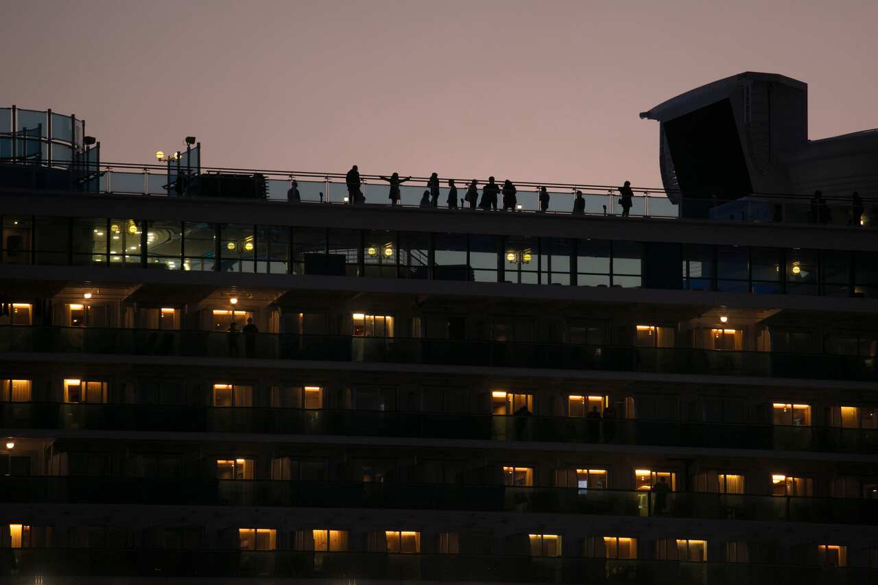 Tourists quarantined on the Diamond Princess cruise ship get some fresh air on the top deck of the ship Thursday, Feb. 13, 2020