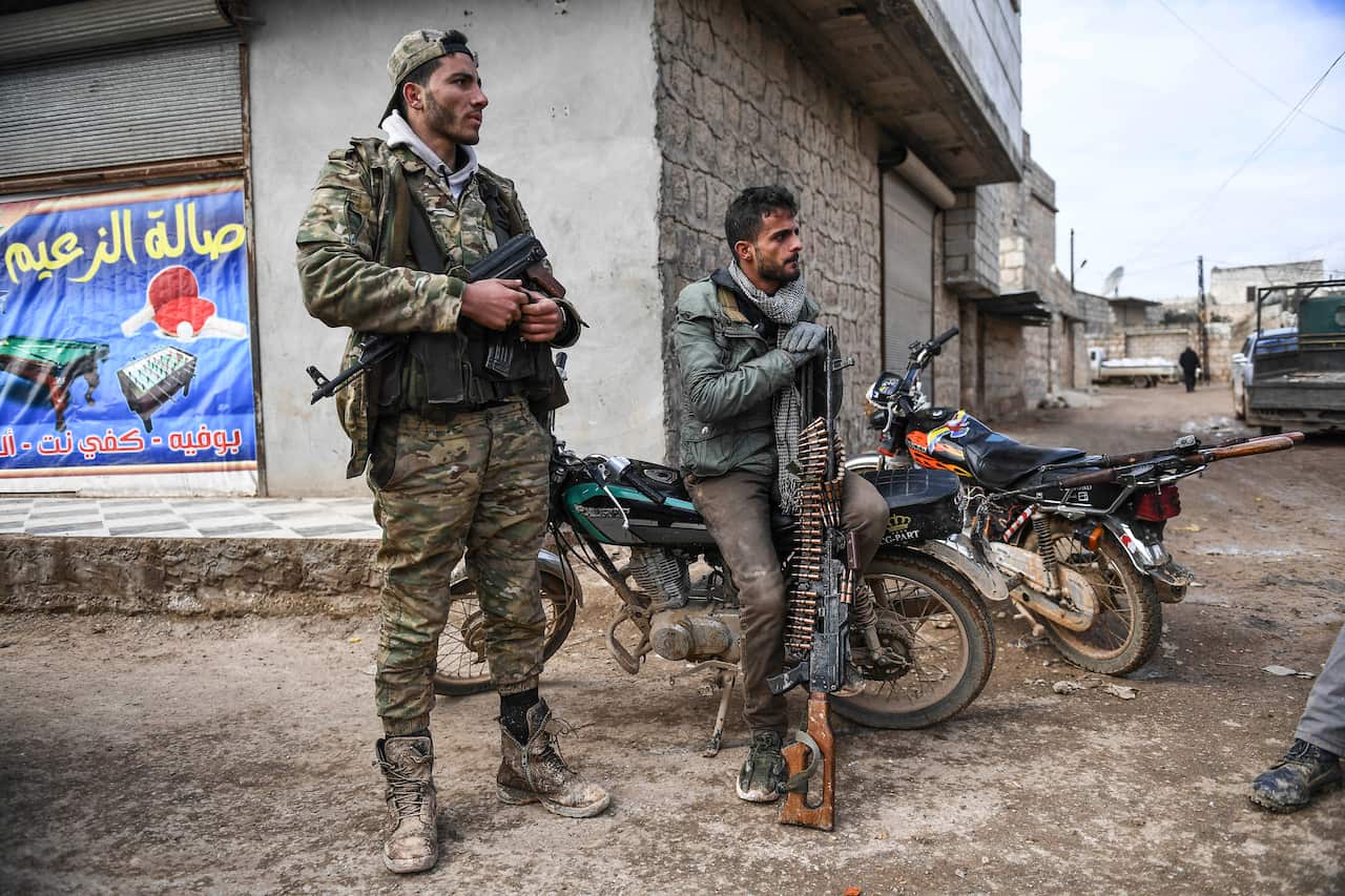 Syrian rebels sit outside Idlib, Syria, Saturday, Feb. 15, 2020. Syrian troops are waging an offensive in the last rebel stronghold. (AP Photo)