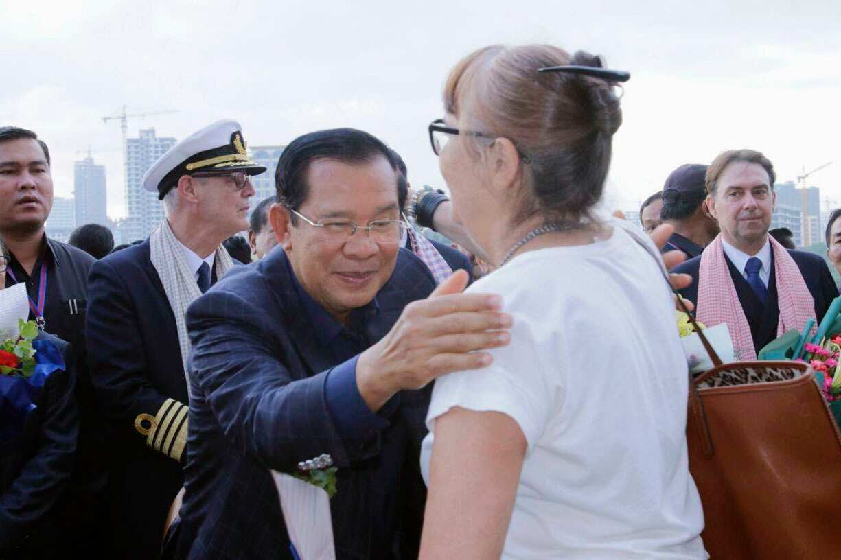 Cambodian Prime Minister Hun Sen greets a passenger of the Westerdam cruise ship.
