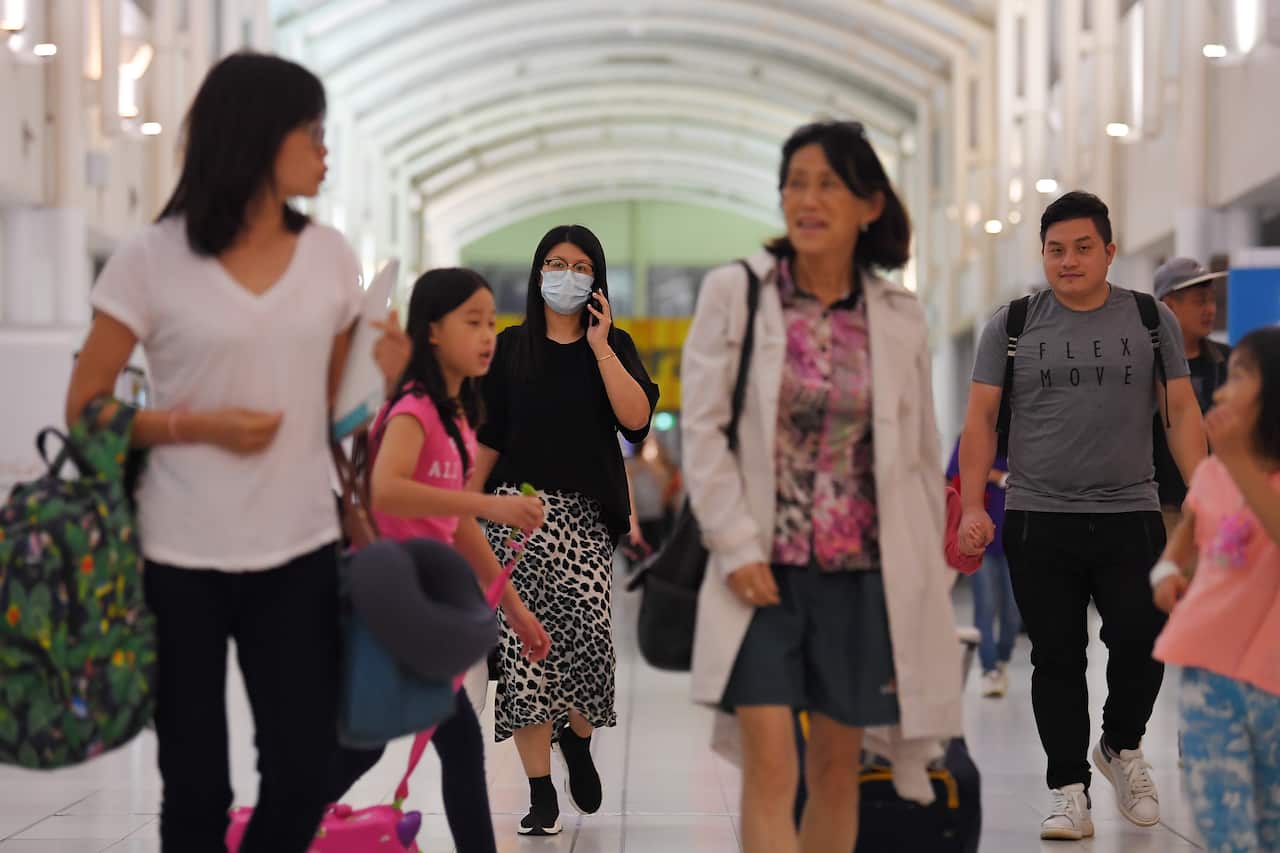 Australian evacuees who were quarantined on Christmas Island arrive at Sydney Airport.