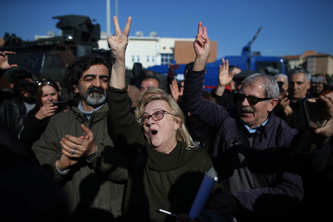 Mucella Yapici, one of 16 defendants, greets to her supporters after the court's verdict in front of the Silivri courthouse in Istanbul.