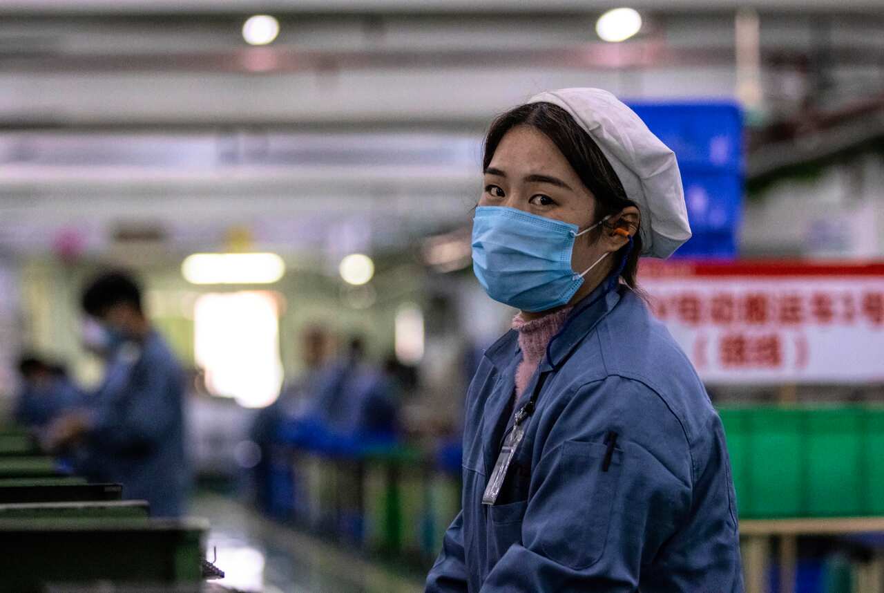 A woman at the Galanz factory in Foshan, China. According to media reports, some factories are resuming operations after shutting down because of the virus.