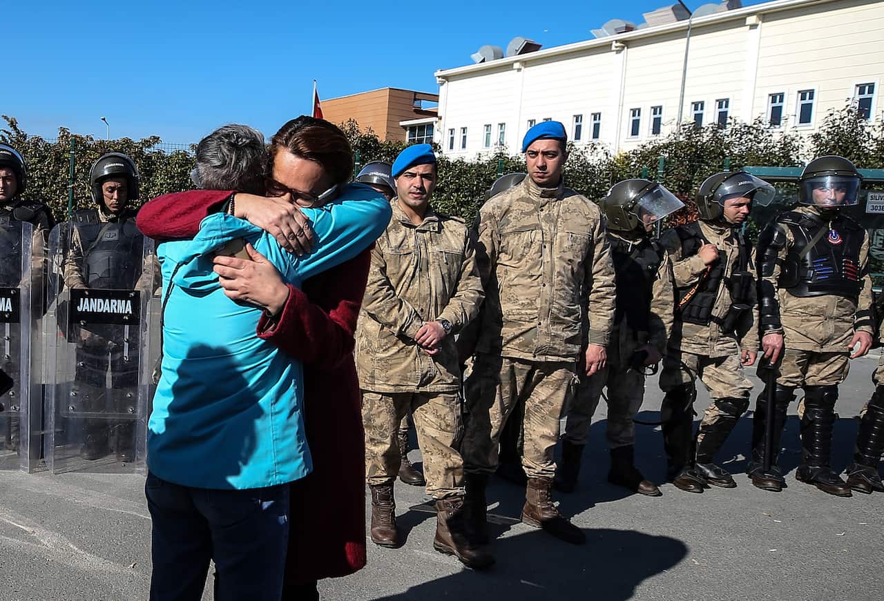 Family members and friends celebrate after a court acquitted nine leading Turkish civil society activists of terrorism-related charges, including Osman Kavala.