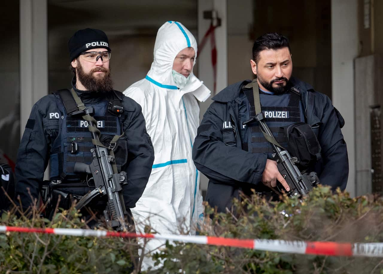 German police officers guard the entrance of a bar where several people were killed late Wednesday.