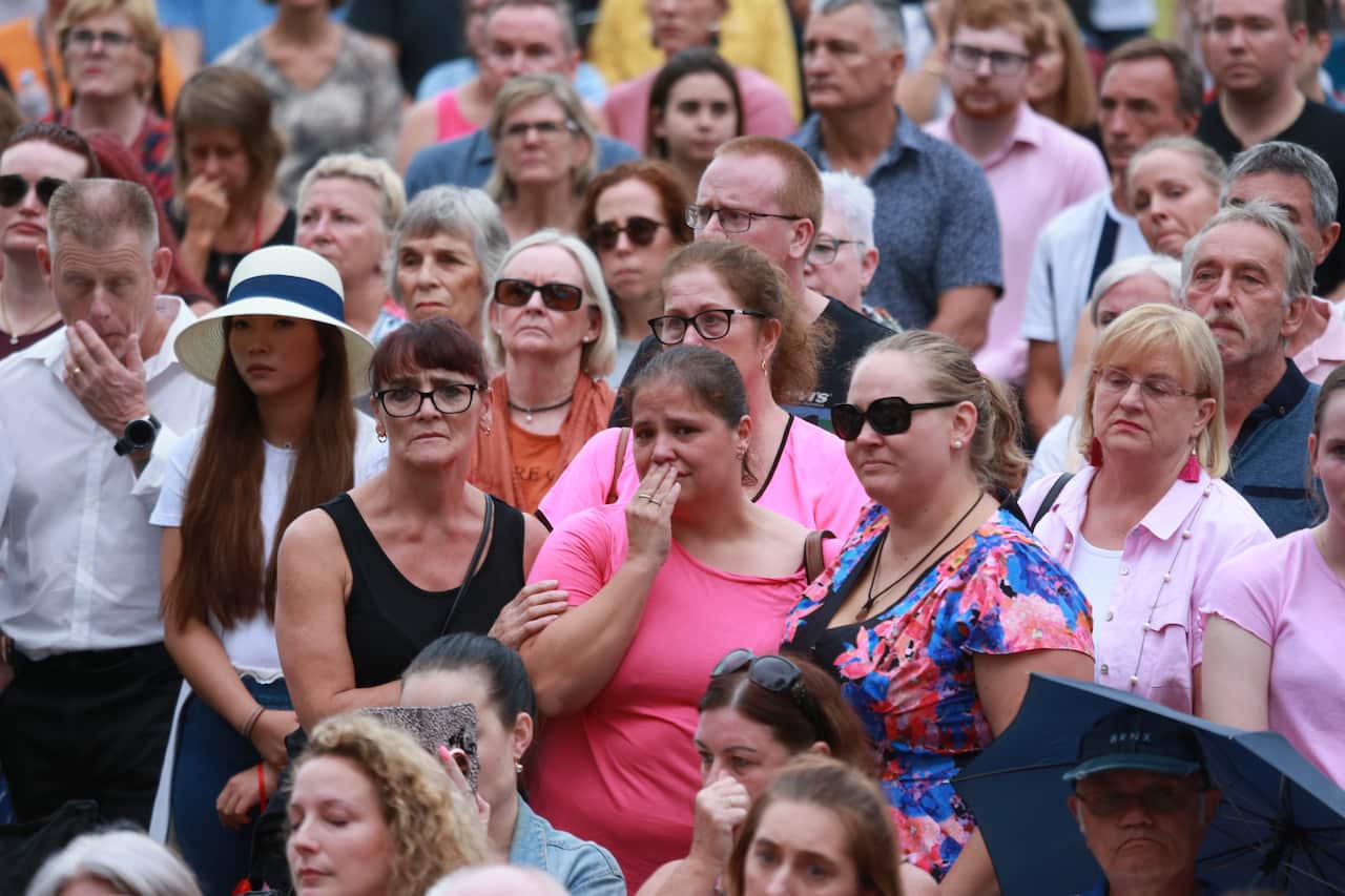 Mourners are seen during a vigil for Hannah Clarke and her three children Aaliyah, 6, Laianah, 4, and Trey, 3, at Bill Hewitt Reserve in Brisbane, Sunday February 23, 2020. (AAP Image/Sarah Marshall) NO ARCHIVING