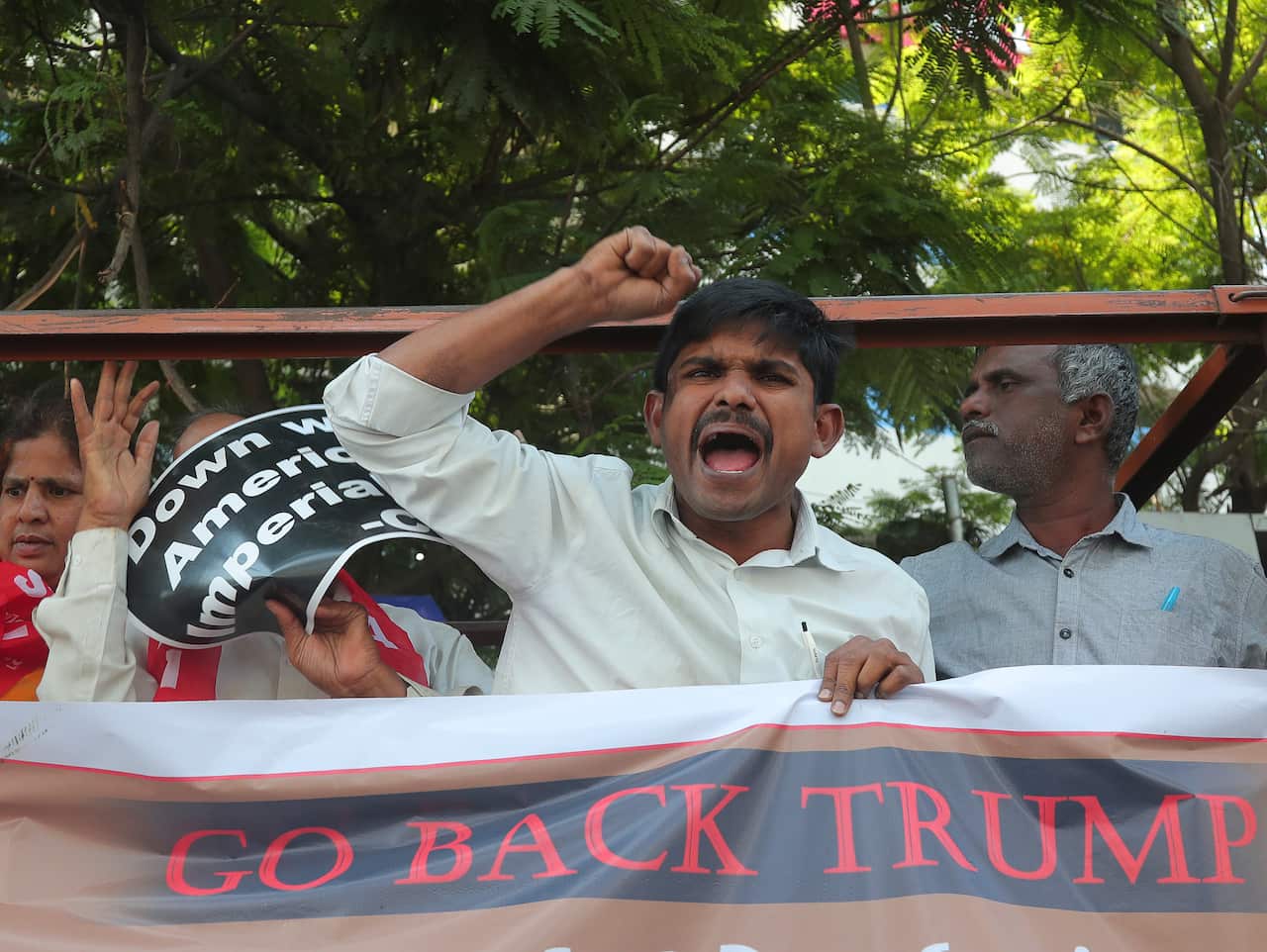 A protester shouts slogans after being detained by police during a protest against US President Donald Trump during his India visit.