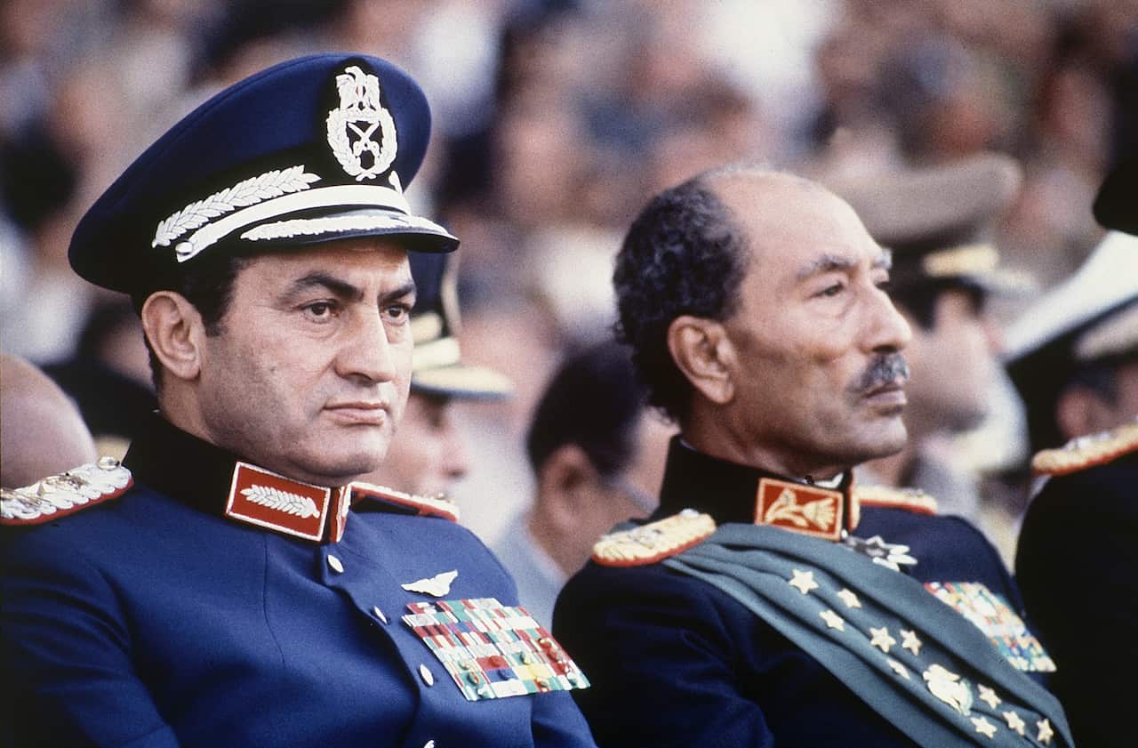 President Anwar Sadat, right, and Vice President Hosni Mubarak watch a parade just before soldiers opened fire, killing President Sadat.