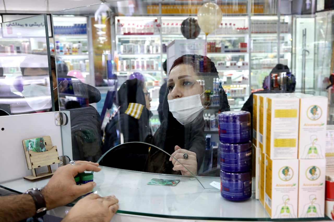 A customer talks with a Pharmacist at a drugstore in downtown Tehran, Iran.