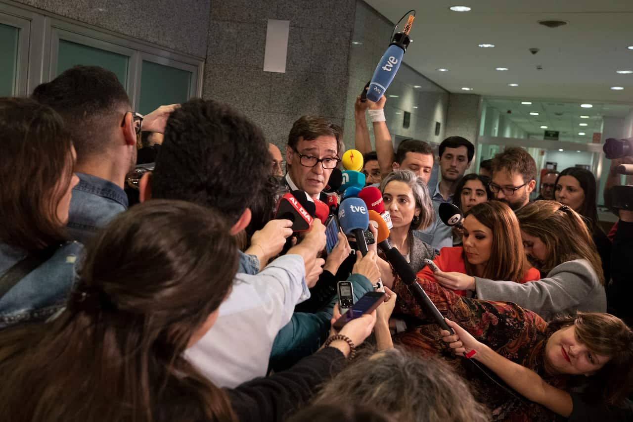 Spain's Health Minister Salvador Illa speaks with journalists before a coronavirus meeting at the Health Ministry in Madrid, Spain.