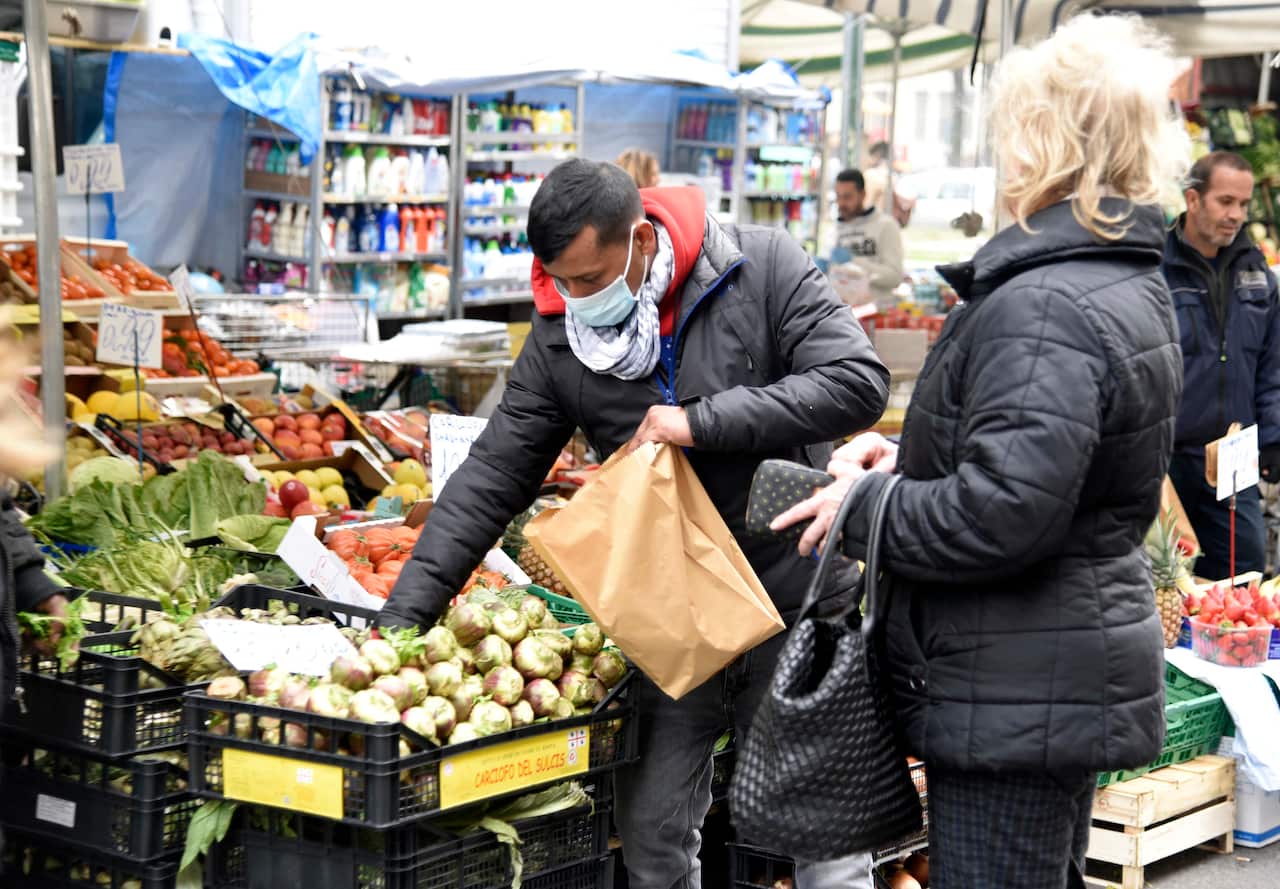 People with mask at Via Fauch market in Milan, Italy on February 25, 2020. Photo by IPA/ABACAPRESS.COM.