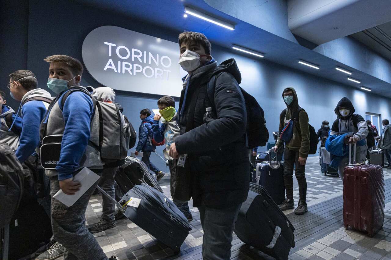 People wearing masks arriving to Sandro Pertini Airport on 28 February, 2020, in Turin Italy. 
