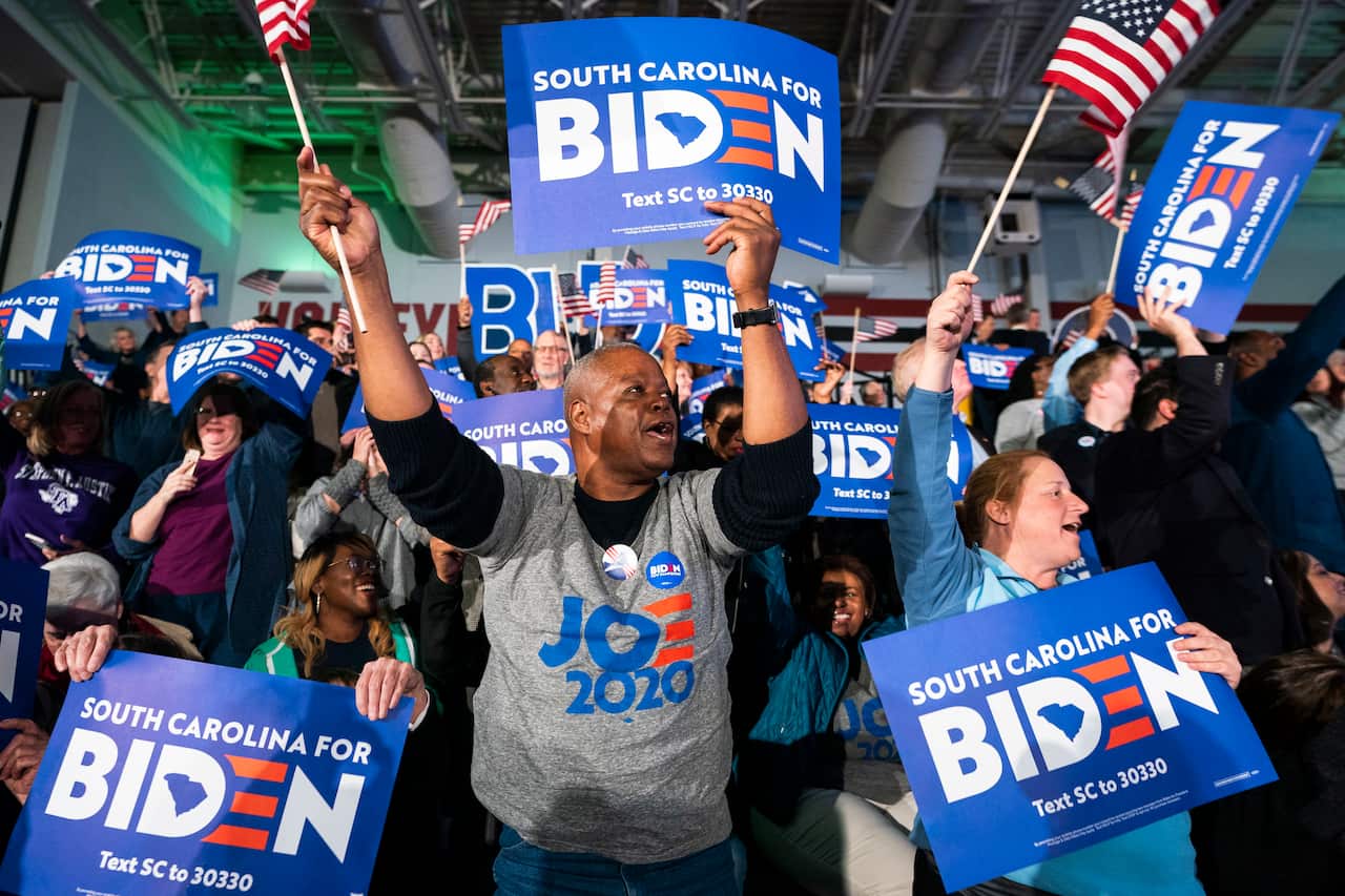 Supporters of US Democratic presidential candidate Joe Biden cheer after he won the South Carolina primary.