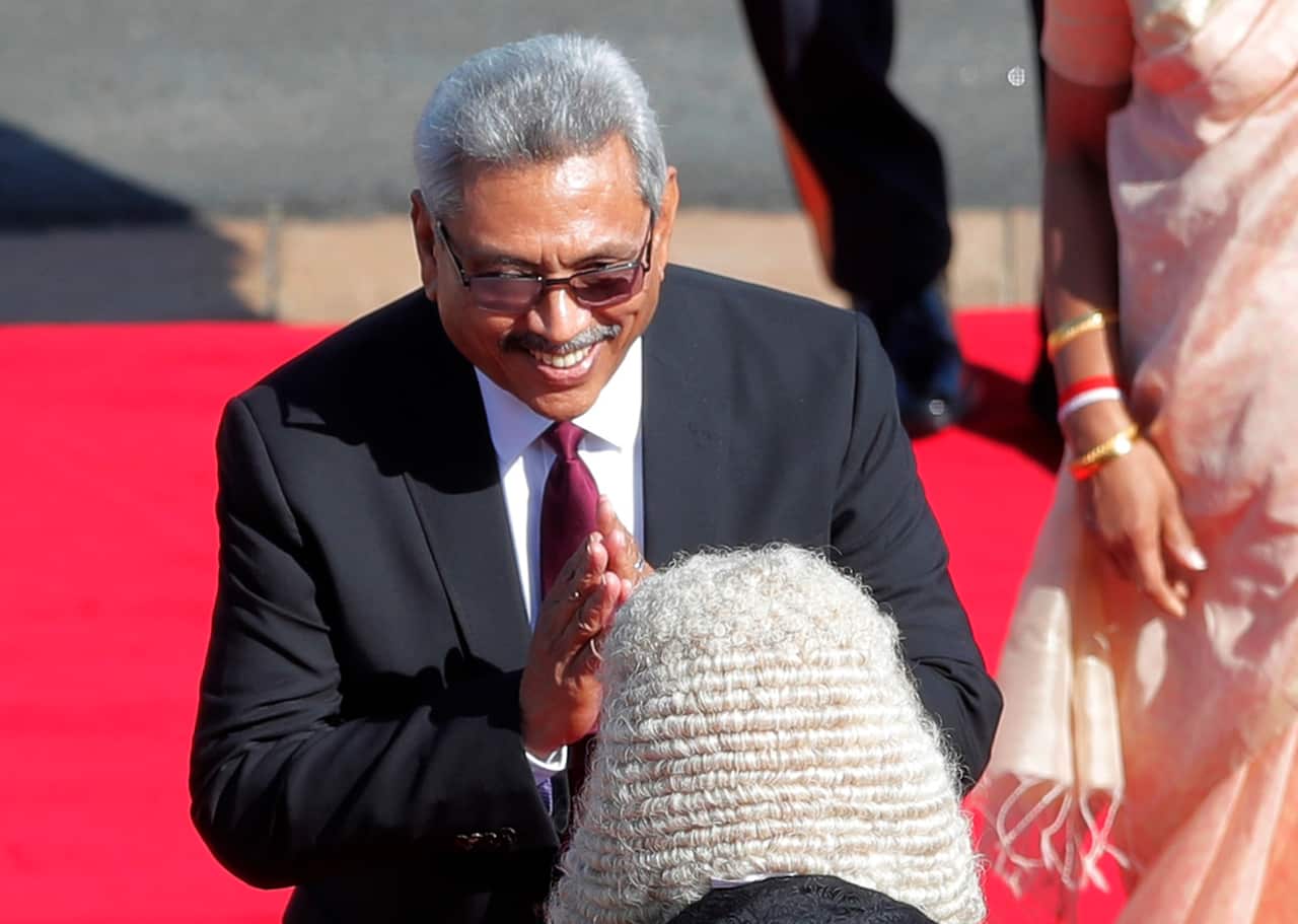 Sri Lankan president Gotabaya Rajapaksa greets speaker Karu Jayasuriya upon his arrival at the parliamentary complex.