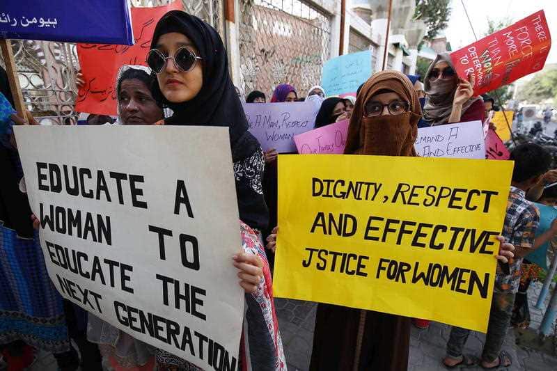 Women hold placards ahead of International Women Day in Karachi, Pakistan, 6 March 2020