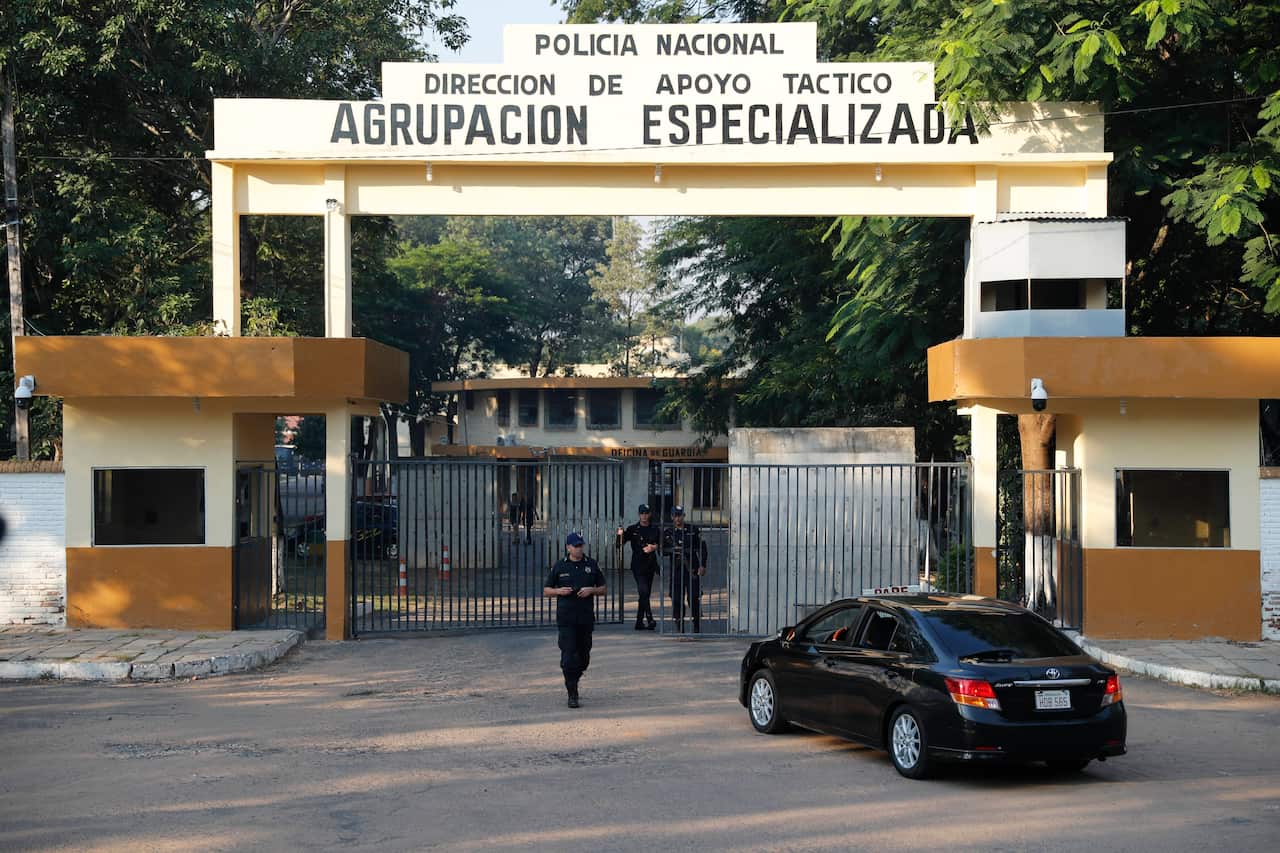 An officer checks a car at the Police Specialized Forces entrance where former soccer star Ronaldinho is detained.