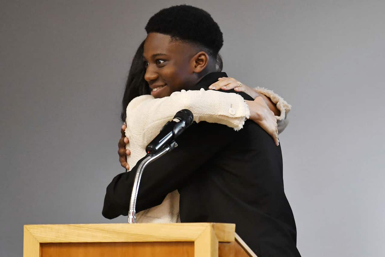 The Duchess of Sussex (left) embraces head boy Aker Okoye.