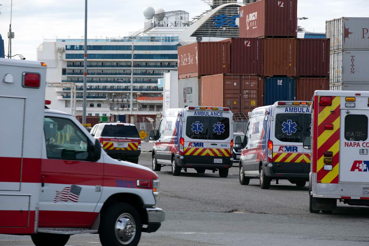Ambulances approach the coronavirus-hit Grand Princess at port in Oakland, California, to take passengers to hospital or into quarantine.