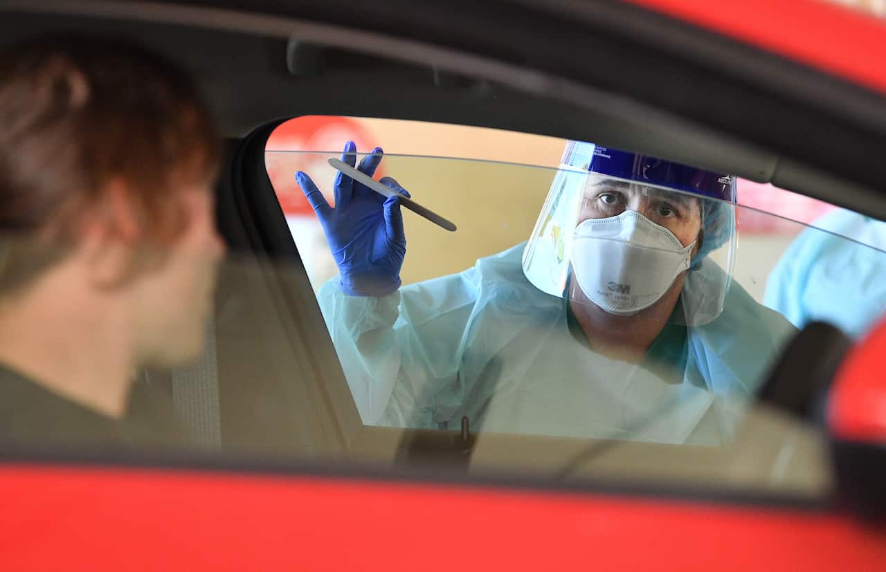 South Australia Hospital staff simulate a drive through coronavirus testing at the Repatriation Hospital in Adelaide, Tuesday, March 10, 2020. (AAP Image/David Mariuz) NO ARCHIVING
