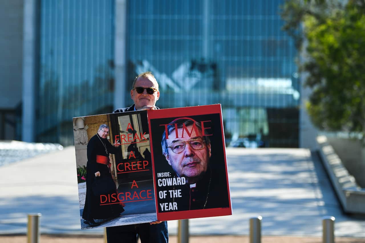 Child sex abuse victim Michael Advocate poses for photographs outside the High Court of Australia.