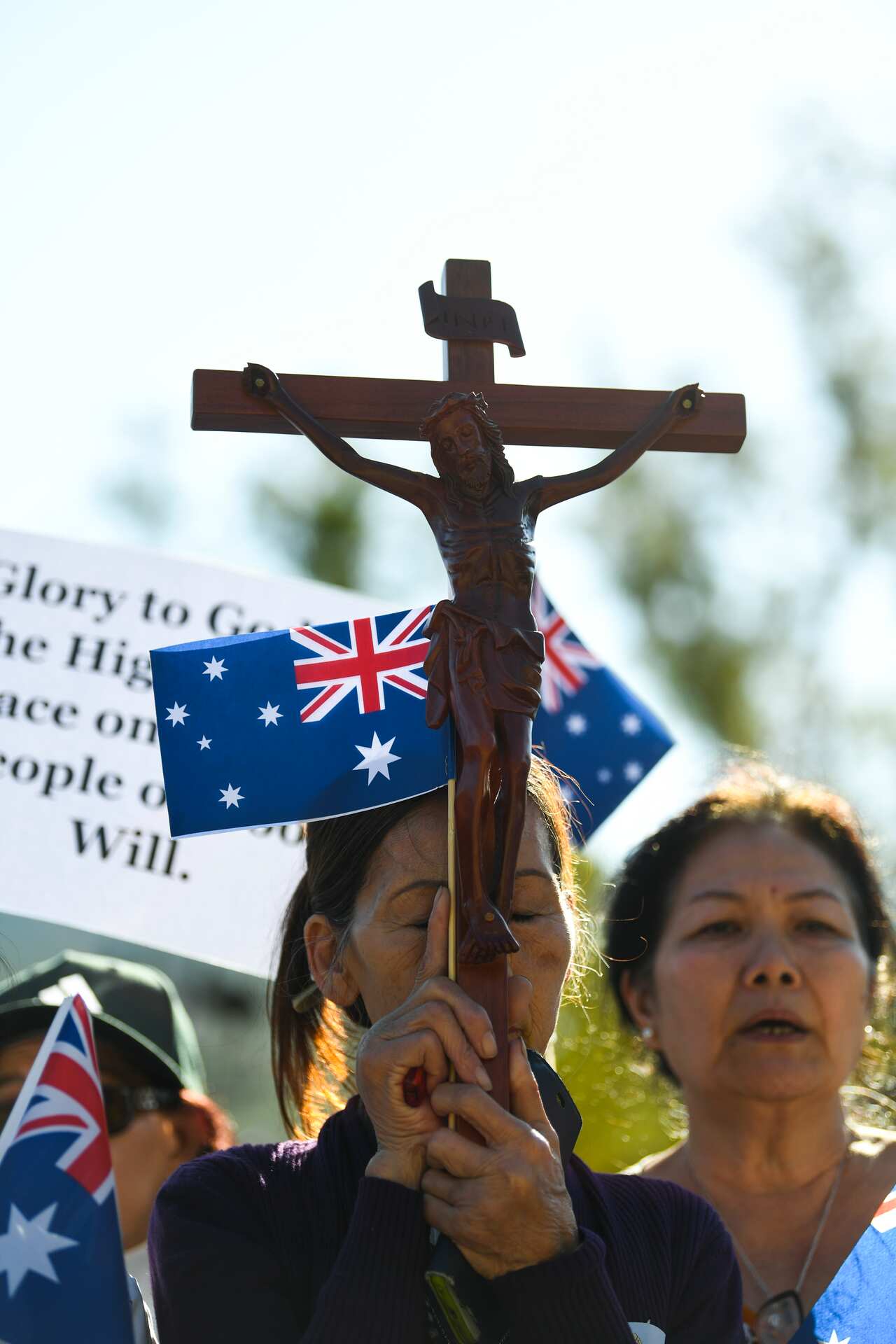 Supporters of George Pell pray outside the High Court of Australia.