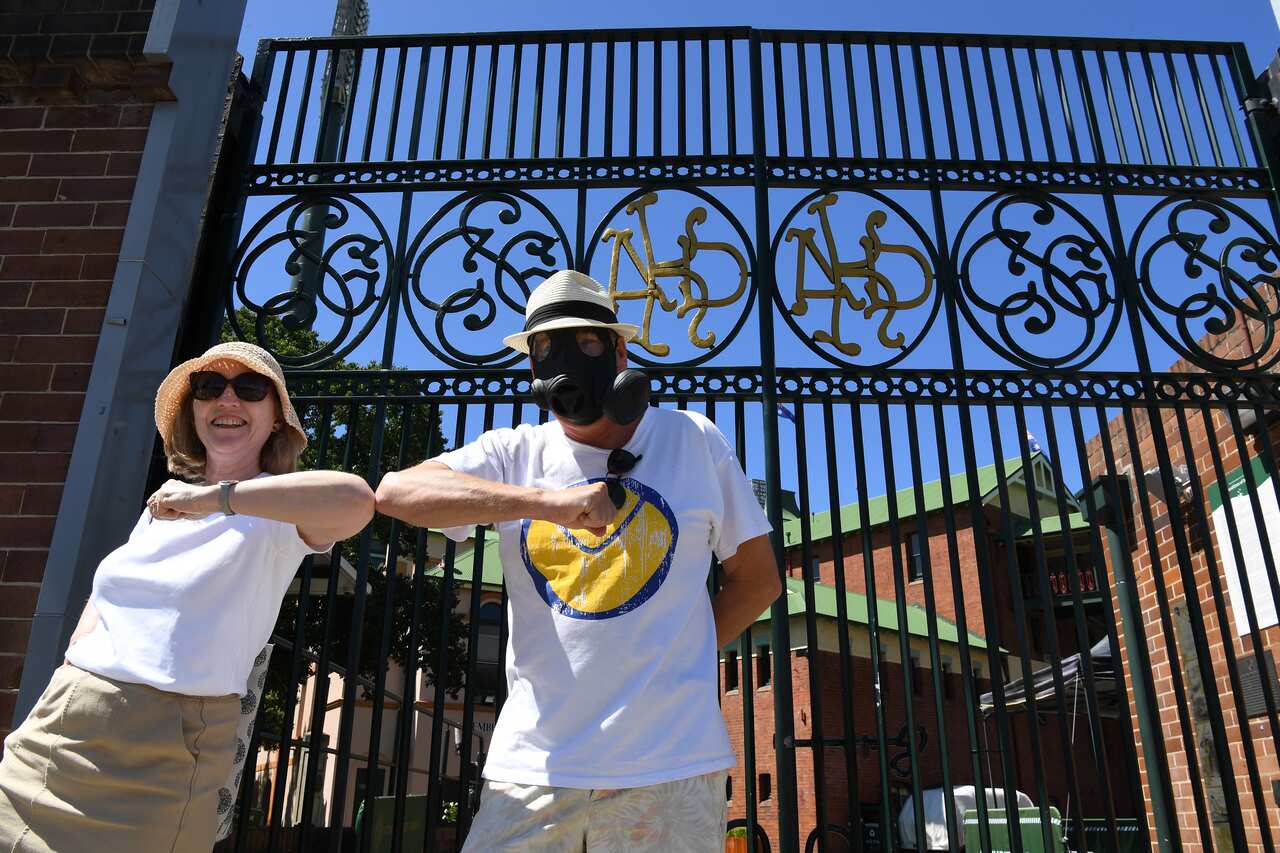 Australians are taking precautions such as wearing masks and tapping elbows instead of shaking hands