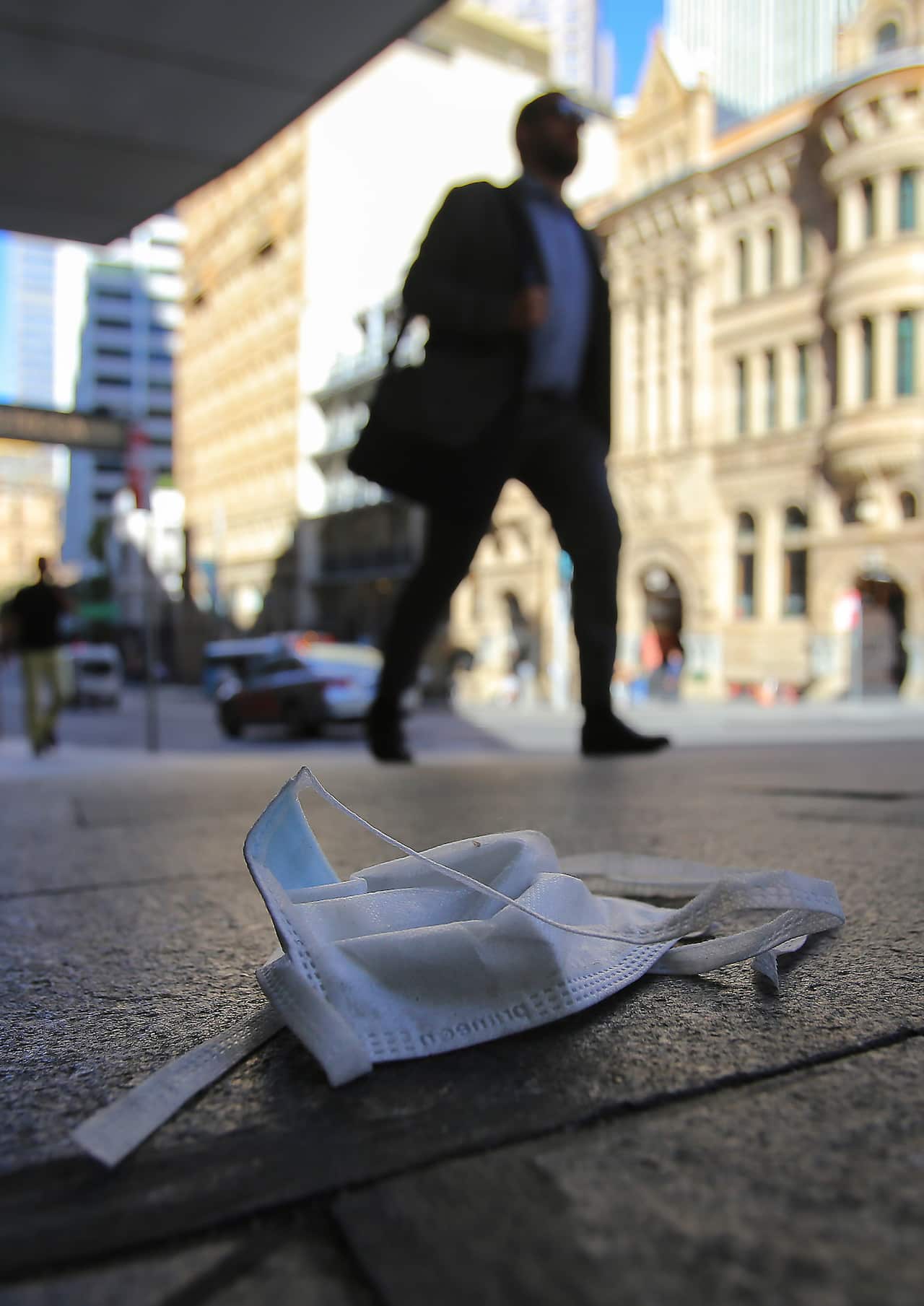 A face mask is seen discarded on the ground in Sydney.