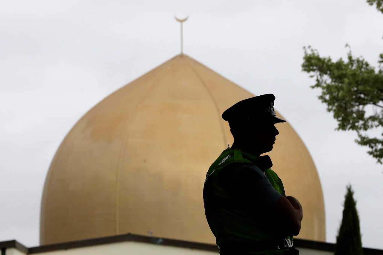 A police officer stands in a park near the Al Noor Mosque in Christchurch.