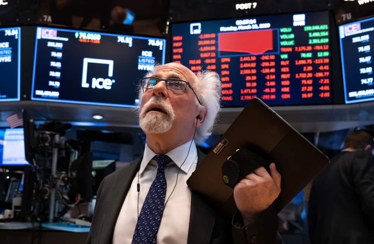 Trader Peter Tuchman works on the floor of the New York Stock Exchange Monday, March 16, 2020. (AP Photo/Craig Ruttle)