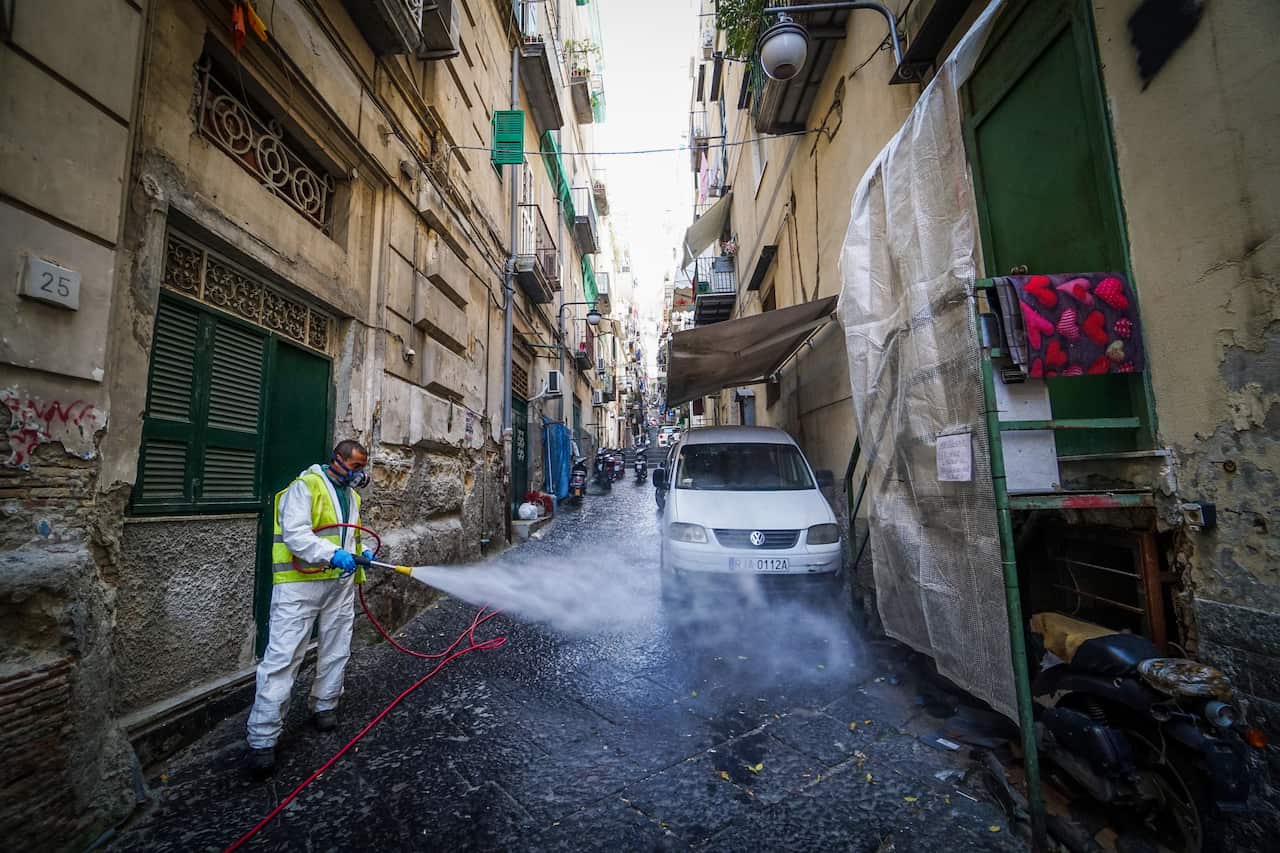 A worker disinfects the street at Quartieri Spagnoli, Naples, Italy, 18 March 2020. 