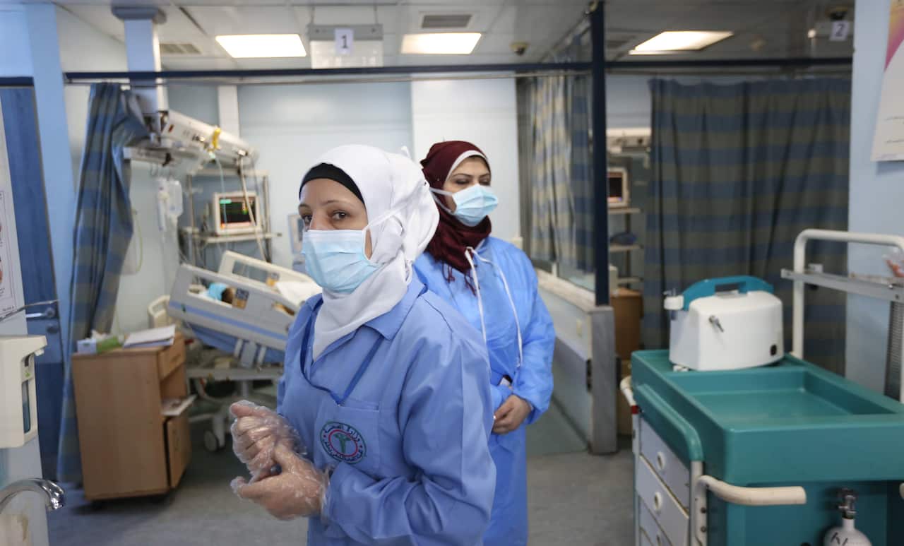 Nurses work in the intensive care unit at the government-run Al Mojtahed hospital in Damascus, Syria