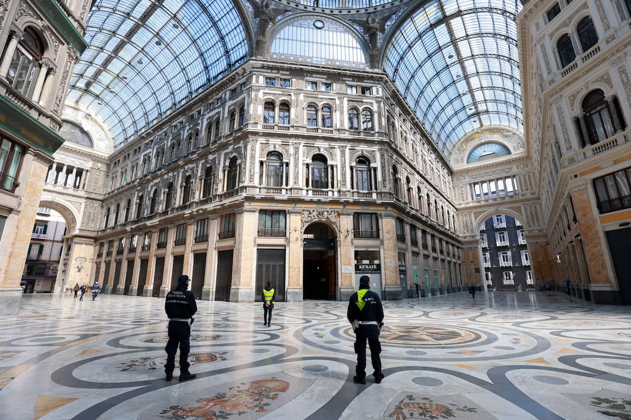 Police patrol the city of Naples to help enforce the mandatory lockdown to combat the spread of COVID-19.