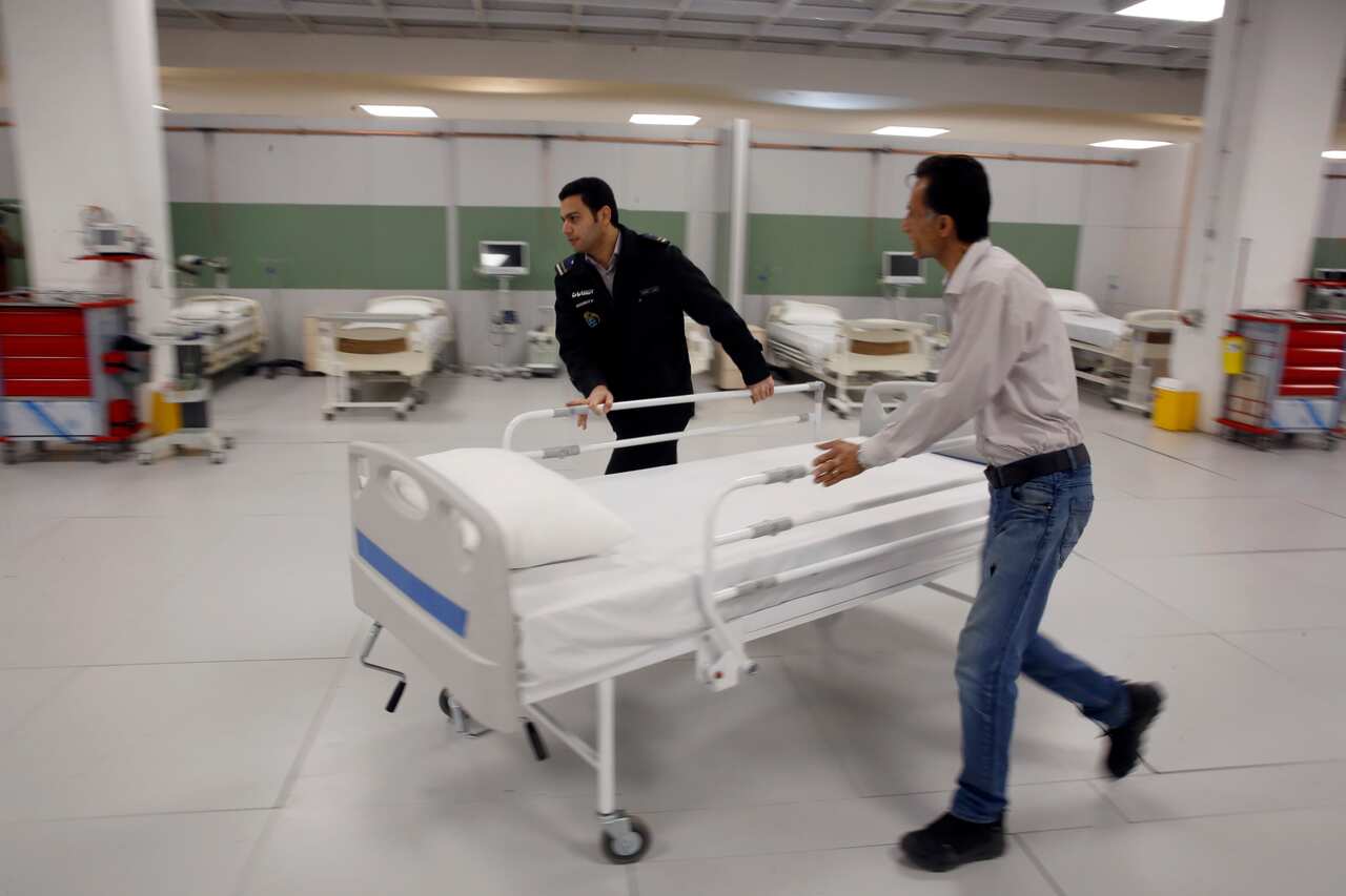 Iranian workers set a temporary established emergency hospital northwest of the capital of Tehran, Iran