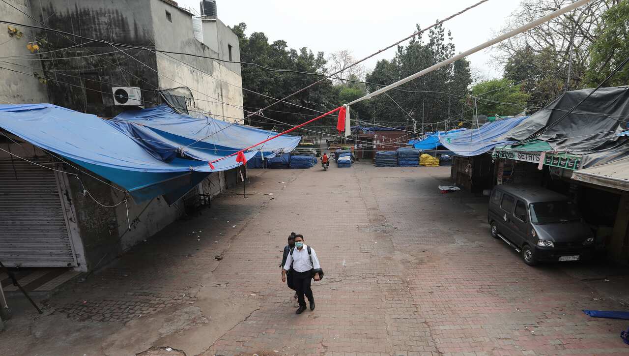 Indian people wearing protective masks in a closed market in New Delhi, India