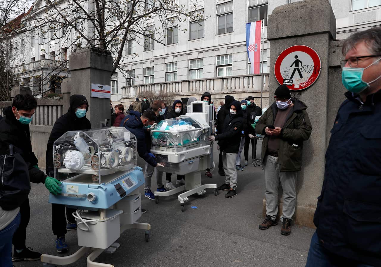 People carry incubators for newborn babies as the hospital is evacuated after an earthquake in Zagreb, Croatia