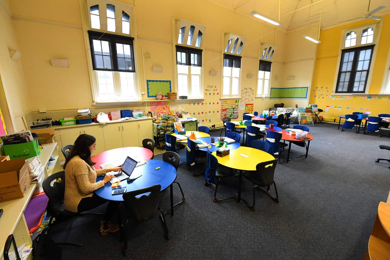 A teacher in an empty primary school classroom in Melbourne's inner north.
