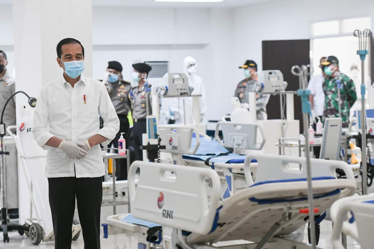 Indonesian President Joko Widodo inspects a room during a visit at the Asian Games athlete's village which has been converted into a temporary hospital.