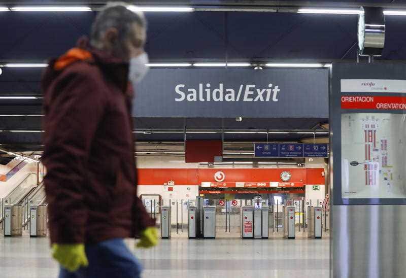 A commuter walks through Nuevos Ministerios Metro station in Madrid.
