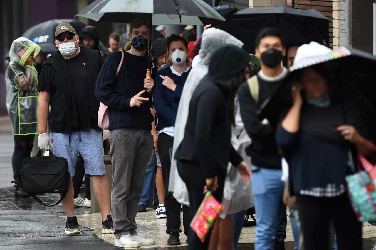 People are seen queuing outside a Centrelink office in Bondi Junction, Sydney, Tuesday, 24 March, 2020.