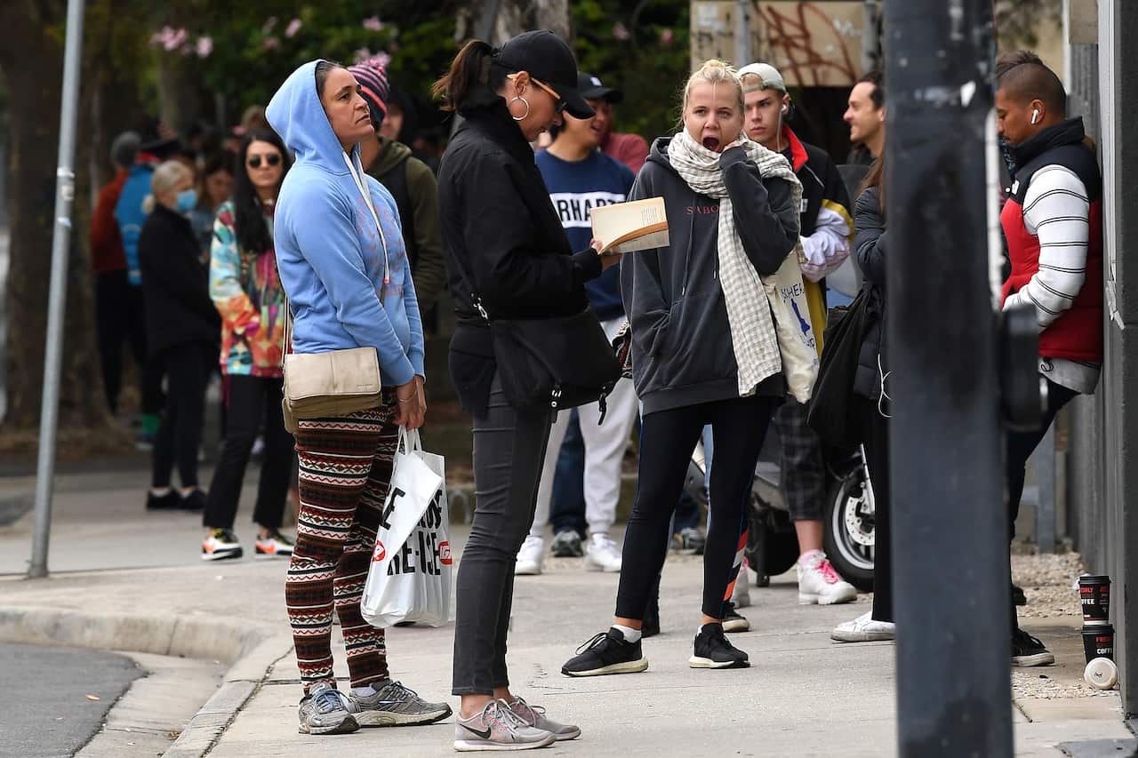 People are seen waiting in line at the Prahran Centrelink office in Melbourne.